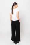 Meet your new go-to: the Billie The Label Essential Wide Leg Pants in classic black. With a sleek flat front waist and comfy elastic back, they fit like a dream. Two handy pockets add practicality to the style, making them perfect for everyday adventures. Crafted from a soft blend of 65% viscose and 35% nylon, these pants offer both comfort and flow with every step.&nbsp;