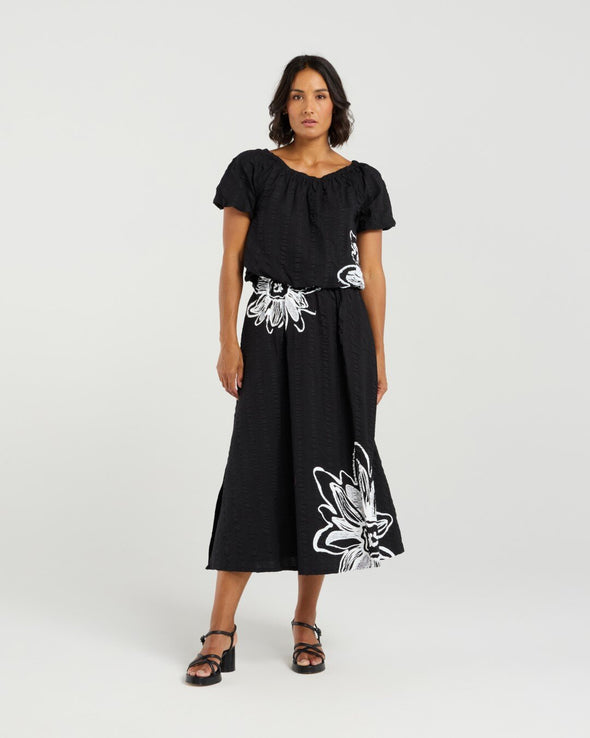 Add a playful touch to your wardrobe with this cropped top, featuring short sleeves and voluminous balloon details at the hem and cuffs for a fun, whimsical shape. The delicate daisy print on the front brings a fresh floral accent to this charming piece. Made from soft 100% rayon, it’s perfect for warm-weather days. Pair it with the matching Daisy skirt for a complete summer-ready look full of cheerful style.