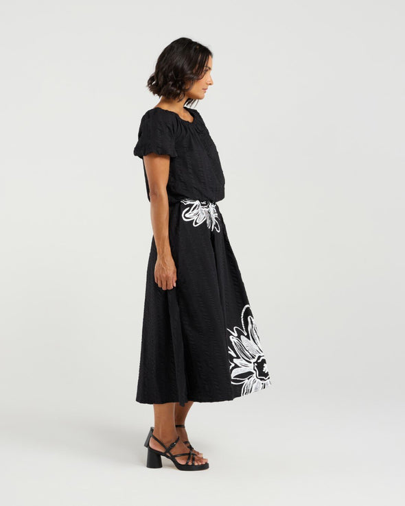 Add a playful touch to your wardrobe with this cropped top, featuring short sleeves and voluminous balloon details at the hem and cuffs for a fun, whimsical shape. The delicate daisy print on the front brings a fresh floral accent to this charming piece. Made from soft 100% rayon, it’s perfect for warm-weather days. Pair it with the matching Daisy skirt for a complete summer-ready look full of cheerful style.