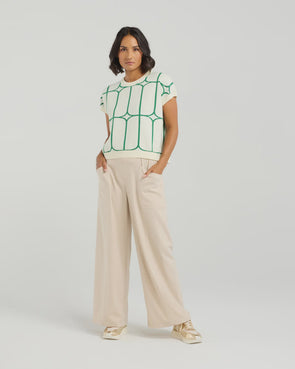 Stay cool and stylish in this summer-ready knit vest that’s full of playful charm. Made from soft knit fabric, it features a bold contrast trellis pattern that adds eye-catching texture. Whether layered over a crisp shirt or worn solo with tailored shorts, this vest brings a fun mix of structure and softness for a polished yet relaxed vibe.