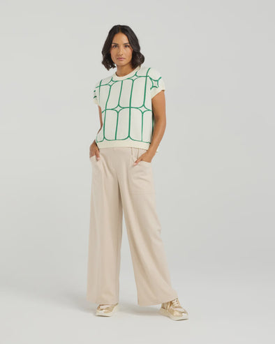 Stay cool and stylish in this summer-ready knit vest that’s full of playful charm. Made from soft knit fabric, it features a bold contrast trellis pattern that adds eye-catching texture. Whether layered over a crisp shirt or worn solo with tailored shorts, this vest brings a fun mix of structure and softness for a polished yet relaxed vibe.
