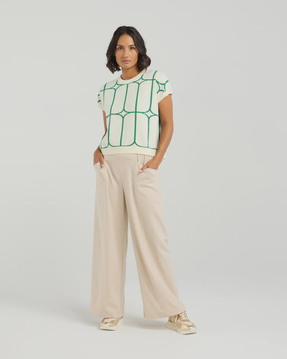 Stay cool and stylish in this summer-ready knit vest that’s full of playful charm. Made from soft knit fabric, it features a bold contrast trellis pattern that adds eye-catching texture. Whether layered over a crisp shirt or worn solo with tailored shorts, this vest brings a fun mix of structure and softness for a polished yet relaxed vibe.