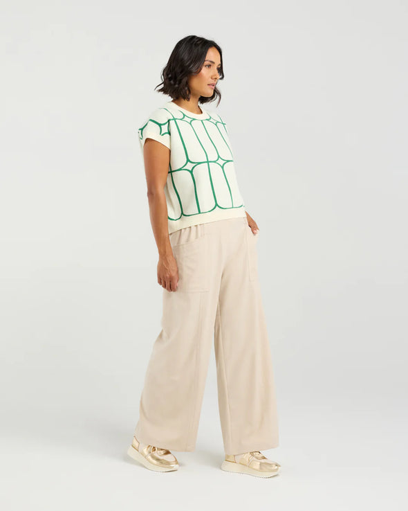 Stay cool and stylish in this summer-ready knit vest that’s full of playful charm. Made from soft knit fabric, it features a bold contrast trellis pattern that adds eye-catching texture. Whether layered over a crisp shirt or worn solo with tailored shorts, this vest brings a fun mix of structure and softness for a polished yet relaxed vibe.