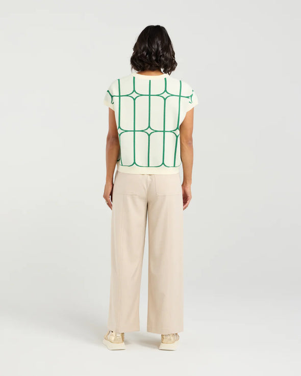Stay cool and stylish in this summer-ready knit vest that’s full of playful charm. Made from soft knit fabric, it features a bold contrast trellis pattern that adds eye-catching texture. Whether layered over a crisp shirt or worn solo with tailored shorts, this vest brings a fun mix of structure and softness for a polished yet relaxed vibe.