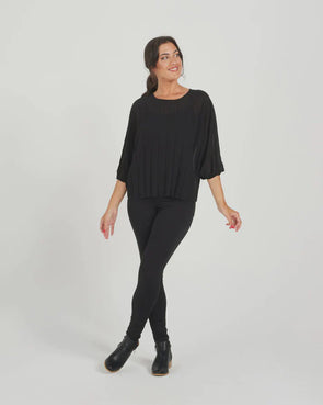 The Aura top in Black is a welcome wardrobe addition. Fantastic for layering and adds a texture element with the pleat detailing. Featuring 3/4 length batwing style sleeves with an elastic cuff and a round neckline. A great option for work or to elevate a casual look. 