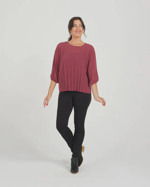 The Aura top in plum is a welcome wardrobe addition. Fantastic for layering and adds a texture element with the pleat detailing. Featuring 3/4 length batwing style sleeves with an elastic cuff and a round neckline. A great option for work or to elevate a casual look. 