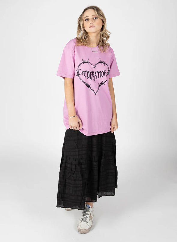 The Rush Tee is our favourite relaxed-fit tee shirt. Taken the best elements of an oversized tee and fine-tuning the shoulders and neckline to stay feminine. The sleeves and the hem have a nice grinning stitch detail too.  Complete with the&nbsp;new Caution print.  COMPOSITION 100% Cotton