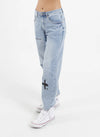 Introducing our Take It Easy Jean. Made with high-quality denim and a relaxed fit, these Black jeans are perfect for everyday wear. The versatile design and ample room for movement make them a must-have addition to your wardrobe. So comfy, you'll never want to take them off! With iconic printed logos on the legs and a fun worded print on the back.