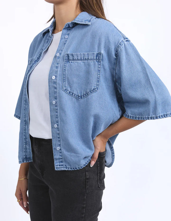 Get ready to elevate your denim game with the Foxwood Hutton Denim Shirt. This versatile shirt features a relaxed, boxy fit and elbow-length sleeves for a stylish update on the classic denim look. Pair it with trousers for a chic outfit, or throw it over a dress for effortless style. Your wardrobe's new MVP has arrived!