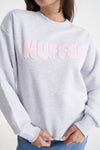 Stay cozy and stylish in the Huffer Crewneck! With a playful twist on the classic crewneck, this sweater features a bold pale pink "Huffer" graphic across the chest in bubble letters. Perfect for any occasion.&nbsp;