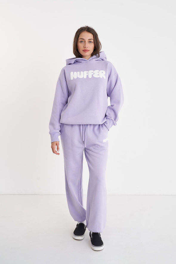 Get ready to rock a cool and playful vibe with our Huffer Hoodie! Featuring bold huffer branding in fun bubble writing, this purple hoodie is the perfect addition to any quirky outfit. Stay cool and stay stylish with this must-have piece.