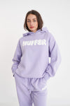 Get ready to rock a cool and playful vibe with our Huffer Hoodie! Featuring bold huffer branding in fun bubble writing, this purple hoodie is the perfect addition to any quirky outfit. Stay cool and stay stylish with this must-have piece.