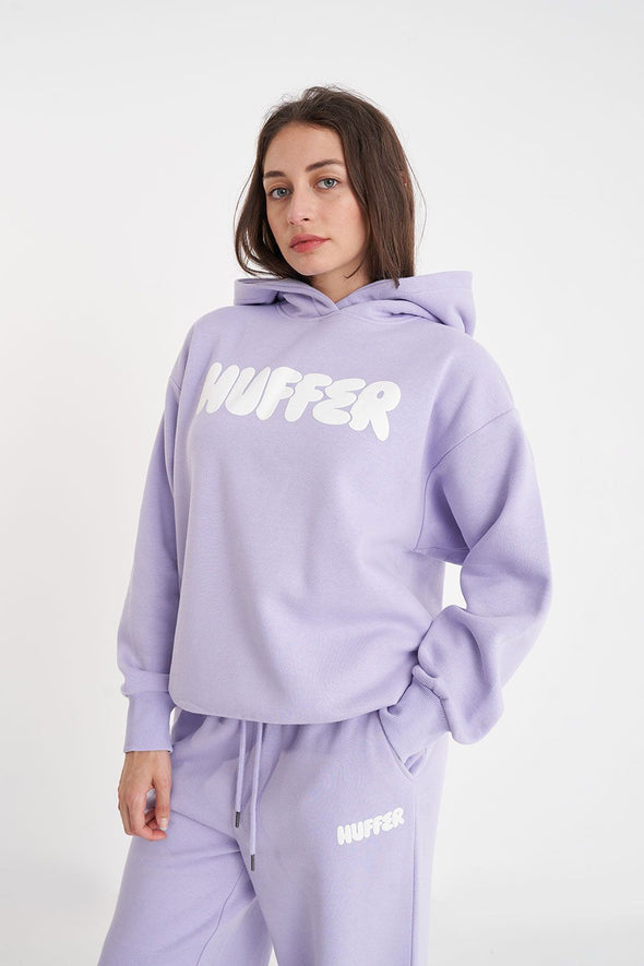 Get ready to rock a cool and playful vibe with our Huffer Hoodie! Featuring bold huffer branding in fun bubble writing, this purple hoodie is the perfect addition to any quirky outfit. Stay cool and stay stylish with this must-have piece.