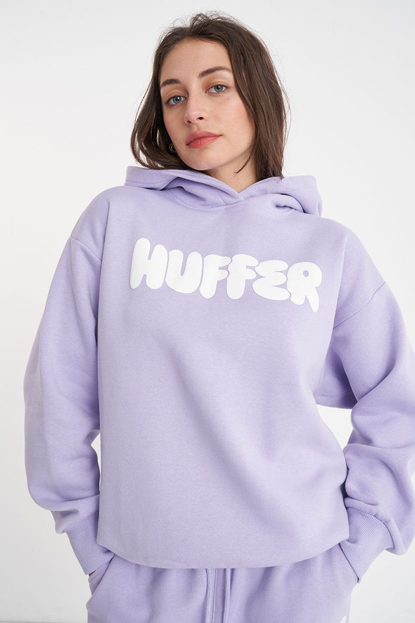 Get ready to rock a cool and playful vibe with our Huffer Hoodie! Featuring bold huffer branding in fun bubble writing, this purple hoodie is the perfect addition to any quirky outfit. Stay cool and stay stylish with this must-have piece.