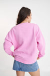 A classic Huffer crewneck in an icon shade of pink; Bon Bon. Rope detail spelling out the word Huffer.