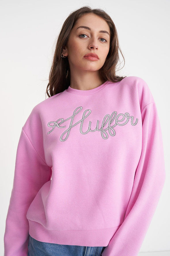 A classic Huffer crewneck in an icon shade of pink; Bon Bon. Rope detail spelling out the word Huffer.