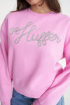 A classic Huffer crewneck in an icon shade of pink; Bon Bon. Rope detail spelling out the word Huffer.