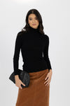 With the cooler months upon us we need to be in our layering era! The Ines Skivvy is not only the softest base layer it also adds texture with the wide ribbed sleeves and creates a snuggly high neckline with the roll over turtle neck. This will look great under a v neck knit or as the elevated basic with a denim skirt or wide leg pant. Fitted although it isn't going to cling.