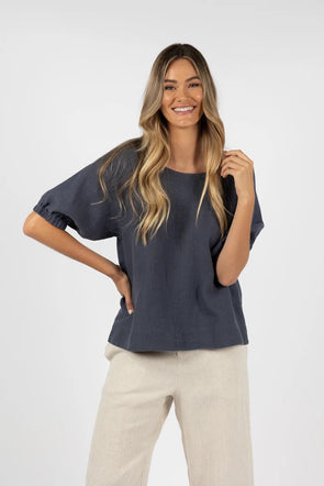 A new take on last season’s favourite top.
Beautiful blouse with round neckline and roomy fit.
Back neck split with button closure.
Soft, floaty sleeves with comfortable elastic at cuff.
This style drapes away from the body, making it super comfortable to wear.
Can be worn tucked in or out.