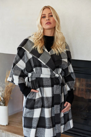 Step into winter sophistication with the Cityscape Jacket, a contemporary update to your outerwear collection. This timeless piece boasts a crossover design, a wide lapel, and a self-fabric belt, adding structure to its oversized silhouette. The elegant contrasting checks bring a refined touch, effortlessly elevating your look, especially when paired with a simple outfit.