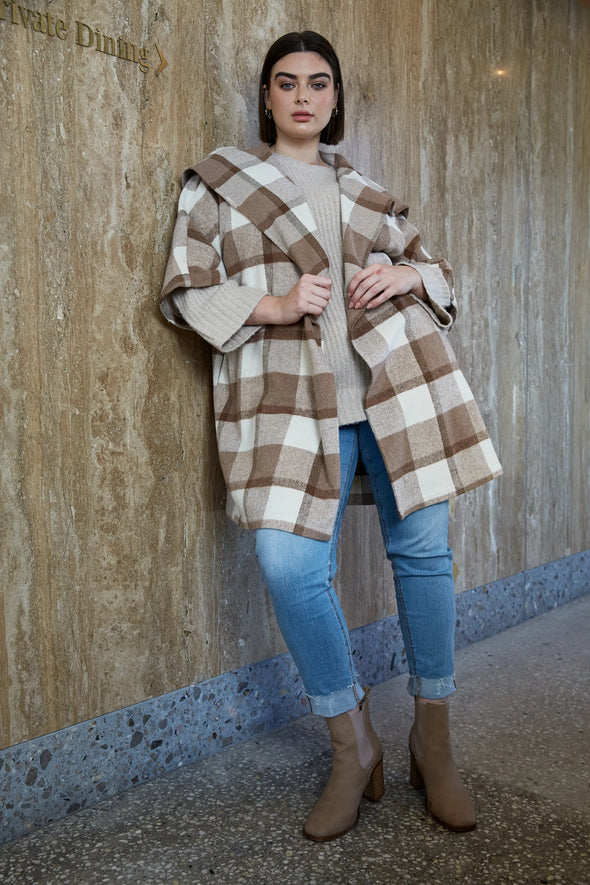 Step into winter sophistication with the Cityscape Jacket, a contemporary update to your outerwear collection. This timeless piece boasts a crossover design, a wide lapel, and a self-fabric belt, adding structure to its oversized silhouette. The elegant contrasting checks bring a refined touch, effortlessly elevating your look, especially when paired with a simple outfit.