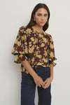 -Pull-on style with a round neckline for fuss-free wear
- Relaxed silhouette with soft gathers for a floaty finish
- Voluminous short sleeves with ruffle detail at the cuff
- All-over floral print in warm chocolate and khaki tones
- 70% Viscose 30% Nylon
