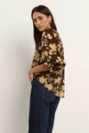 -Pull-on style with a round neckline for fuss-free wear
- Relaxed silhouette with soft gathers for a floaty finish
- Voluminous short sleeves with ruffle detail at the cuff
- All-over floral print in warm chocolate and khaki tones
- 70% Viscose 30% Nylon