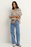 Oversized fit with flowing movement

Ruffle collar and elastic cuffs for added shape

Subtle v-neckline with easy pull-on design

Chocolate-toned animal print for a bold yet elevated look

Crafted from a breathable Tencel, linen, and nylon blend