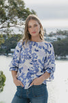 Meet the Candid Ivory Top—romance meets whimsy in soft blue hues and playful floral prints. Its flutter sleeves and relaxed fit bring effortless charm, making it a breeze to style with denim or layer under a blazer. Ready to add a touch of polished fun to your outfit without any fuss? This top’s got you covered!
