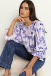 Meet the Candid Ivory Top—romance meets whimsy in soft blue hues and playful floral prints. Its flutter sleeves and relaxed fit bring effortless charm, making it a breeze to style with denim or layer under a blazer. Ready to add a touch of polished fun to your outfit without any fuss? This top’s got you covered!