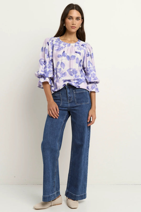 Meet the Candid Ivory Top—romance meets whimsy in soft blue hues and playful floral prints. Its flutter sleeves and relaxed fit bring effortless charm, making it a breeze to style with denim or layer under a blazer. Ready to add a touch of polished fun to your outfit without any fuss? This top’s got you covered!