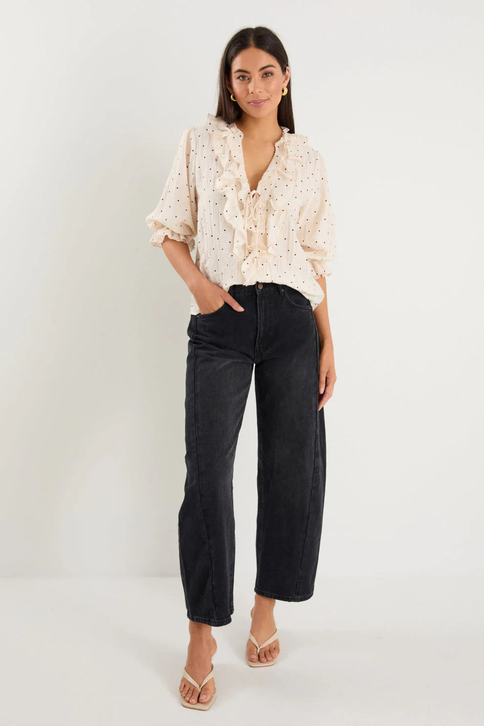 - 75% viscose, 15% linen, 10% polyester for a soft, airy feel
- Mid-length sleeves with gentle volume
- Button front with feminine tie and ruffle detail
- Classic spot print for playful versatility
- Delicate fabric, best cared for gently