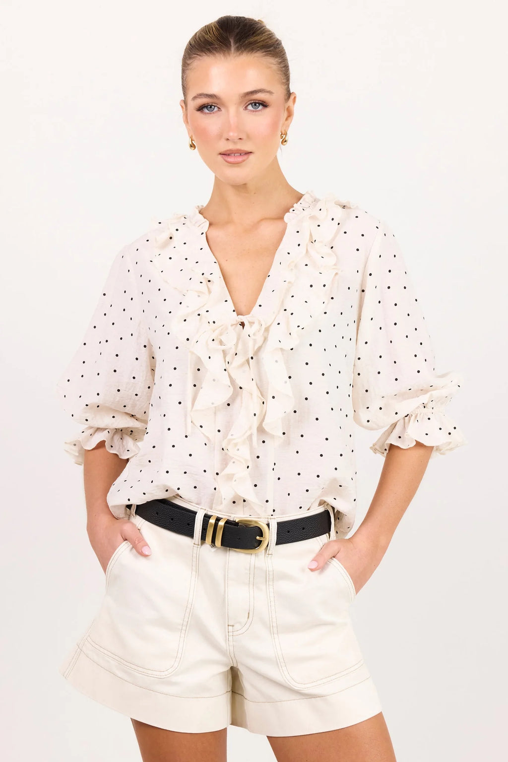 - 75% viscose, 15% linen, 10% polyester for a soft, airy feel
- Mid-length sleeves with gentle volume
- Button front with feminine tie and ruffle detail
- Classic spot print for playful versatility
- Delicate fabric, best cared for gently