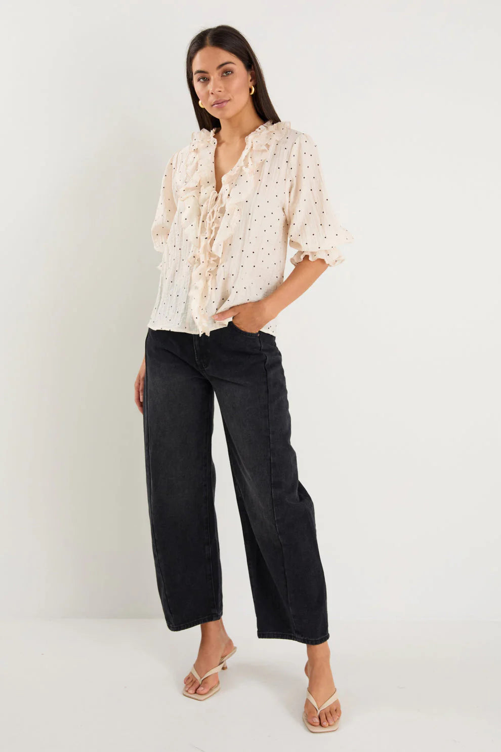 - 75% viscose, 15% linen, 10% polyester for a soft, airy feel
- Mid-length sleeves with gentle volume
- Button front with feminine tie and ruffle detail
- Classic spot print for playful versatility
- Delicate fabric, best cared for gently