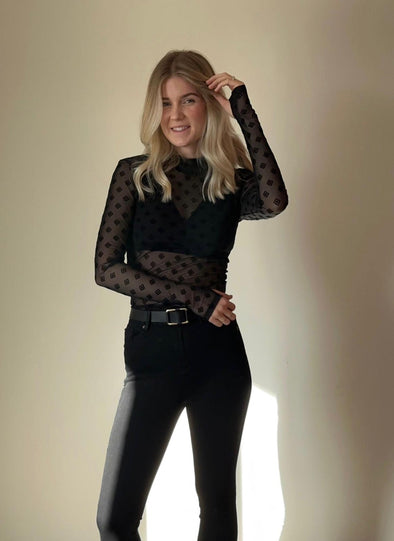 Unleash your inner fashion icon with the Ksubi Symbols Long Sleeve Top Black. This slim-fit mesh top features a mock neckline and subtle detailing, perfect for pairing with denim and a bralette for a flirty evening outfit. Its premium stretch mesh fabric is adorned with a tonal black t-box pattern, adding a touch of playfulness to your wardrobe. Get ready to rock a sleek and simple yet stylish look!