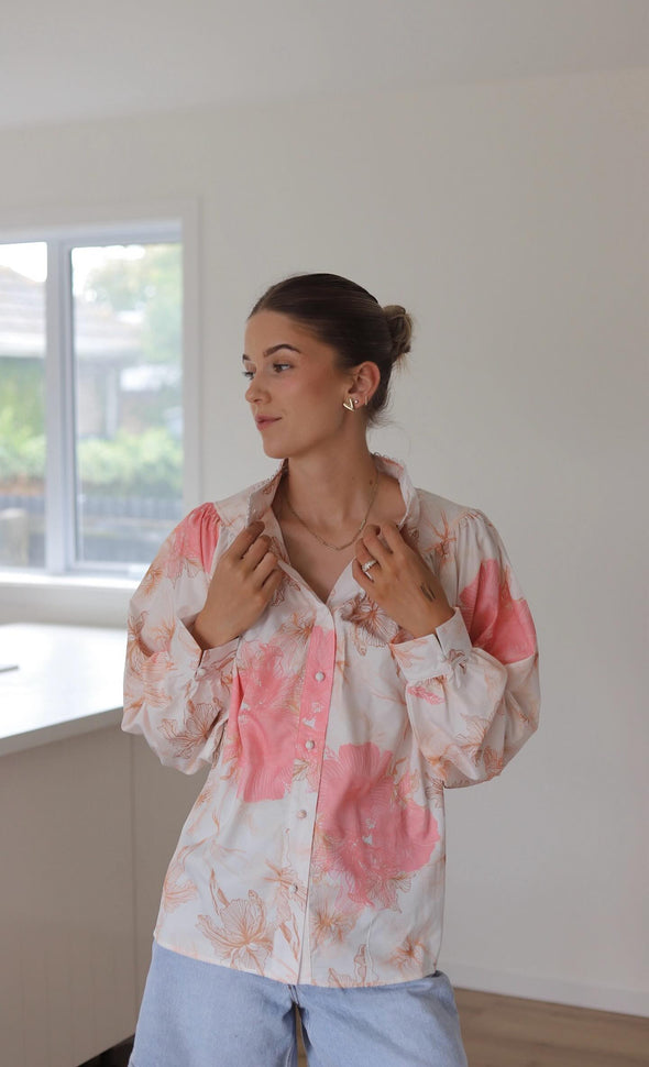 We have found the top that will be your 'nice top to go with your jeans' delicate with a white a pastel pink and natural print and feature button loops and matching fabric buttons. The shoulders have a slight lift with a gather stitch and the cuffs feature a button with split which adds to the delicate charm of this shirt.