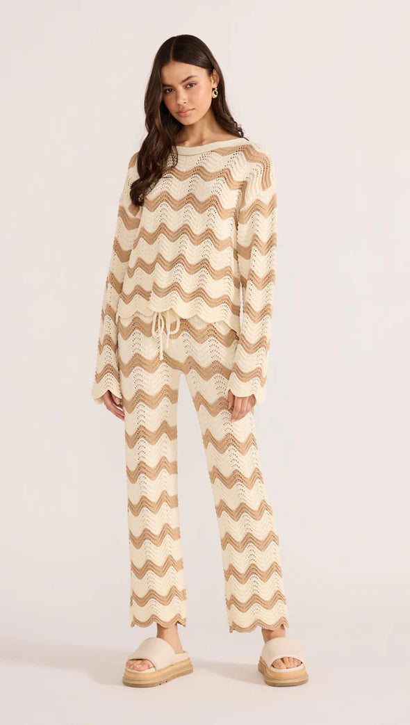 Introducing the Brooke Crochet Sweater - luxuriously soft and effortlessly chic. Its vintage-inspired zig-zag pattern and earthy tones bring a touch of '70s glamour to any outfit. With its relaxed silhouette and scalloped hem, this statement piece is perfect for both casual and coordinated looks. Embrace laid-back elegance with the Brooke Crochet Sweater.