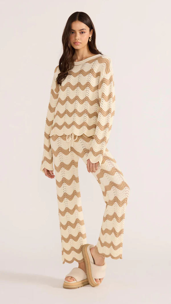 Introducing the Brooke Crochet Sweater - luxuriously soft and effortlessly chic. Its vintage-inspired zig-zag pattern and earthy tones bring a touch of '70s glamour to any outfit. With its relaxed silhouette and scalloped hem, this statement piece is perfect for both casual and coordinated looks. Embrace laid-back elegance with the Brooke Crochet Sweater.
