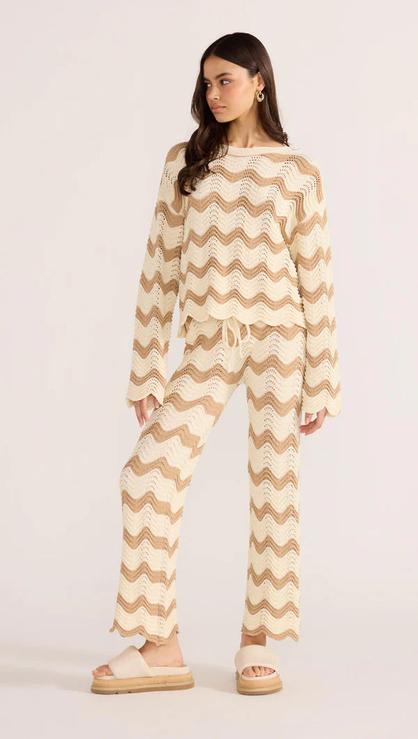 Introducing the Brooke Crochet Sweater - luxuriously soft and effortlessly chic. Its vintage-inspired zig-zag pattern and earthy tones bring a touch of '70s glamour to any outfit. With its relaxed silhouette and scalloped hem, this statement piece is perfect for both casual and coordinated looks. Embrace laid-back elegance with the Brooke Crochet Sweater.