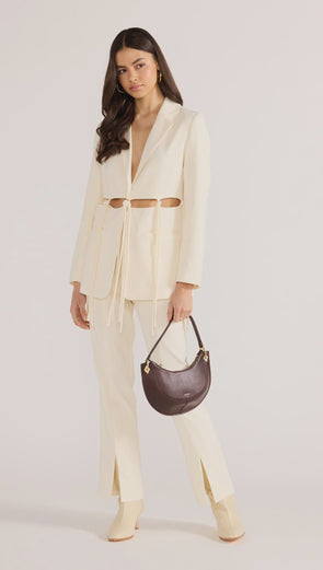 Introducing the Maeve Tie Blazer, a modern take on power dressing. With its structured tailoring and unique cut-out tie details, this blazer exudes sophistication and edge. Complete the look with the Maeve Panel Pant for a powerful suiting ensemble. Elevate your style with this exclusive piece.