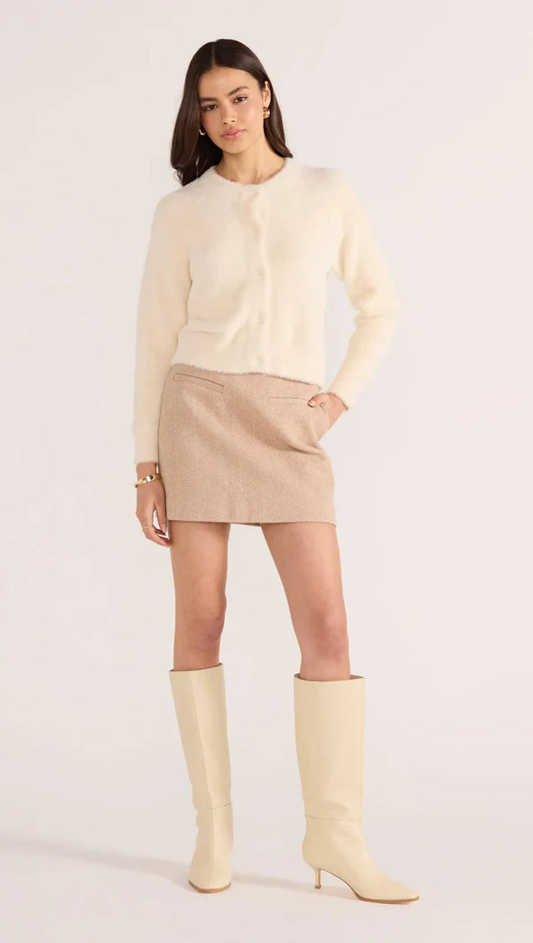 Introducing the Rowan Fluffy Cardi in ivory, a cozy and feminine addition to your wardrobe. Crafted from a super-soft, brushed knit, this timeless cardigan exudes effortless refinement. Wear it over a slip dress, with denim, or pair it with a Mini Skirt for a sophisticated mix of texture and polish.