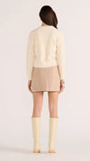 Introducing the Rowan Fluffy Cardi in ivory, a cozy and feminine addition to your wardrobe. Crafted from a super-soft, brushed knit, this timeless cardigan exudes effortless refinement. Wear it over a slip dress, with denim, or pair it with a Mini Skirt for a sophisticated mix of texture and polish.