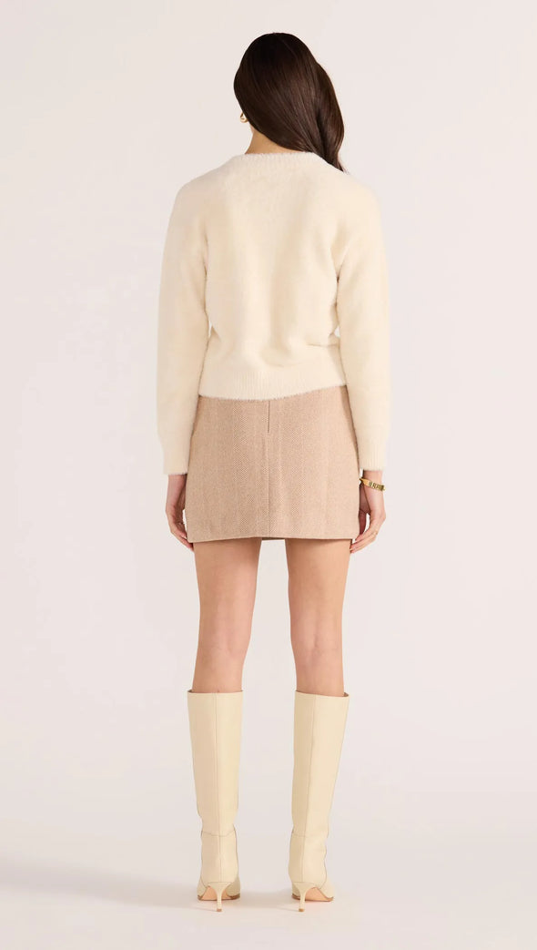 Introducing the Rowan Fluffy Cardi in ivory, a cozy and feminine addition to your wardrobe. Crafted from a super-soft, brushed knit, this timeless cardigan exudes effortless refinement. Wear it over a slip dress, with denim, or pair it with a Mini Skirt for a sophisticated mix of texture and polish.
