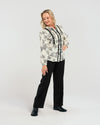 Say hello to Seduce's Abigail Blouse - a chic long-sleeve shirt, crafted with a relaxed fit and adorned with a timeless black floral pattern. The pleated upper bodice flatters your figure, while delicate lace along the placket adds a touch of feminine charm. Perfect for any occasion, this versatile piece combines style and refined details for a polished, modern look. Elevate your wardrobe with this exclusive design.