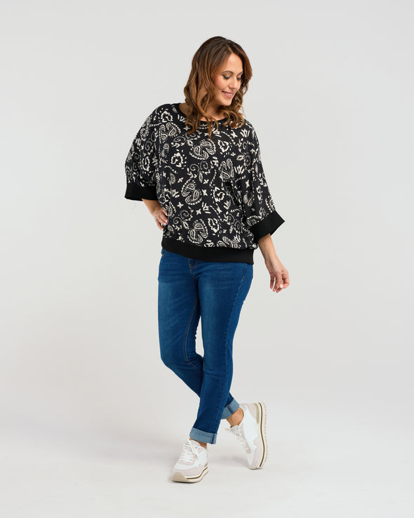 Indulge in effortless everyday luxury with this relaxed-fit top. Adorned in a white paisley print with a sleek black base, and finished with striking black cuffs, it exudes effortless style. With its 3/4 sleeves and comfortable fit, it's the perfect choice for any occasion. So simple to style you will find yourself reaching for the Florence top time and time again.