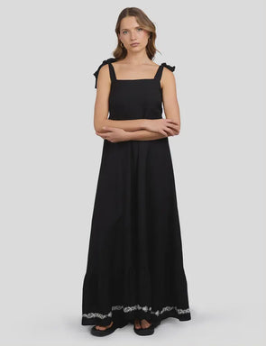 This black maxi dress blends breezy viscose and linen for a light, comfortable feel, perfect for sunny days. The white stitch detailing around the hem adds a cheeky touch of charm, while the tie straps let you customize the fit just right. Lined with soft 100% cotton, it moves effortlessly from casual hangouts to playful evenings out.