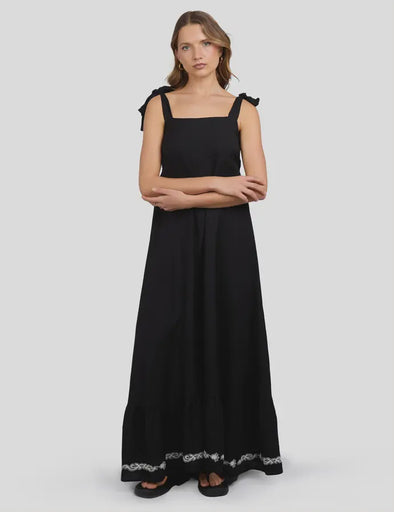 This black maxi dress blends breezy viscose and linen for a light, comfortable feel, perfect for sunny days. The white stitch detailing around the hem adds a cheeky touch of charm, while the tie straps let you customize the fit just right. Lined with soft 100% cotton, it moves effortlessly from casual hangouts to playful evenings out.