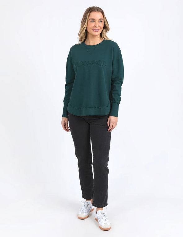 Add a pop of colour to your casual wardrobe with the Foxwood Simplified Crew in Forest Green. This vibrant crew is the ultimate layering piece, designed to bring both comfort and style to your everyday outfits. Featuring a relaxed round neckline, a flattering hi-lo hemline with side splits, and trendy raw edge detailing, this crew offers an effortlessly cool vibe. The embroidered Foxwood logo on the chest adds a touch of signature style, making this a go-to piece for any casual look.

Made from 100% cotton,