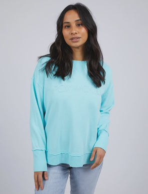 Add a pop of colour to your casual wardrobe with the Foxwood Simplified Crew in Light Blue. This vibrant crew is the ultimate layering piece, designed to bring both comfort and style to your everyday outfits. Featuring a relaxed round neckline, a flattering hi-lo hemline with side splits, and trendy raw edge detailing, this crew offers an effortlessly cool vibe. The embroidered Foxwood logo on the chest adds a touch of signature style, making this a go-to piece for any casual look.

Made from 100% cotton, i