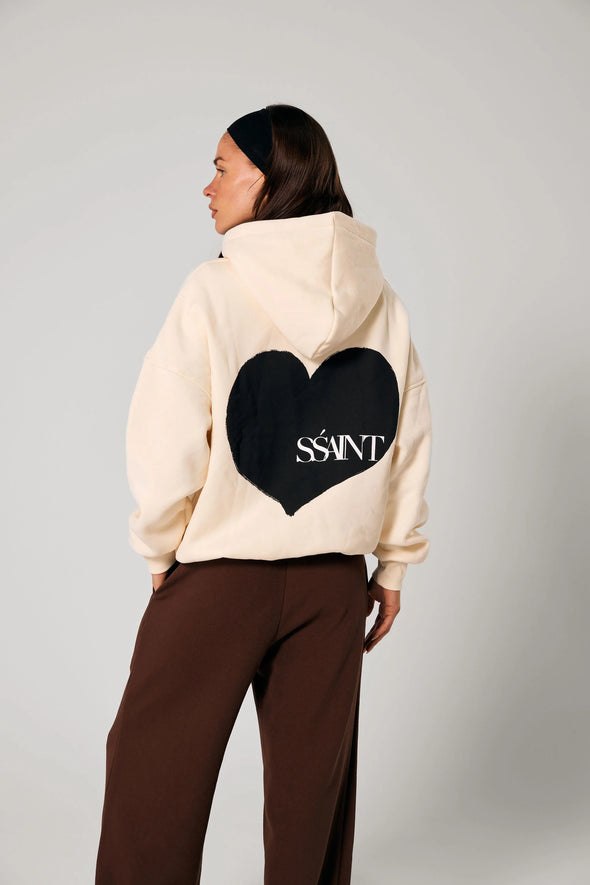 Elevate your off-duty style with the SŚAINT Butter Hoodie – where comfort meets bold design. Crafted from a soft and durable 50% cotton, 50% polyester blend, this fleece-lined hoodie is the perfect throw-on for cooler days.